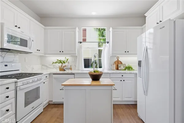 a kitchen with stainless steel appliances white cabinets stove and refrigerator