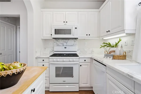 a kitchen with stainless steel appliances white cabinets and a stove