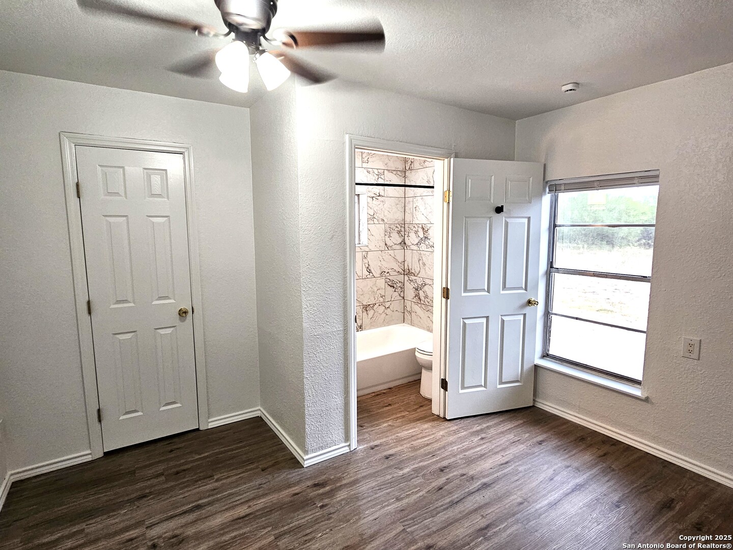 105 Santa Clara Street Cibolo, TX 78108 - Photo 13 of 35 an empty room with wooden floor fan and windows