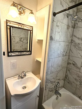 a bathroom with a sink and mirror with toilet