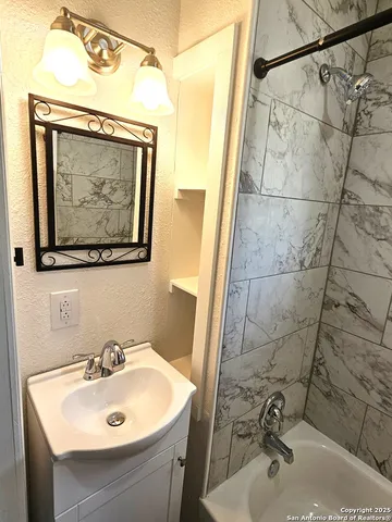 a bathroom with a sink and mirror with toilet
