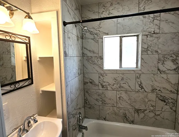 a bathroom with a bathtub and a shower