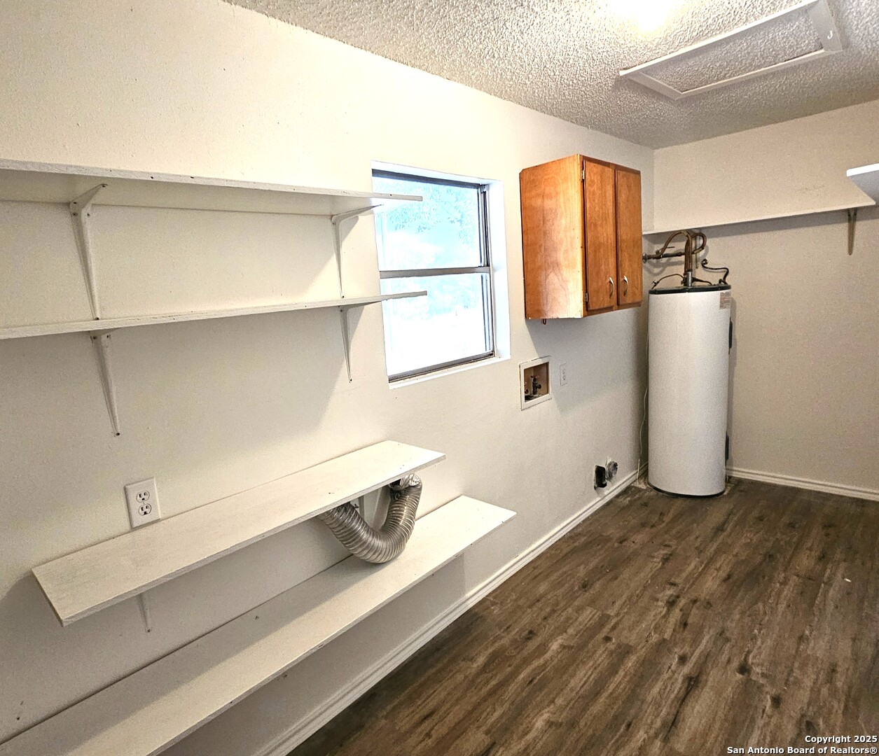 105 Santa Clara Street Cibolo, TX 78108 - Photo 19 of 35 a view of a kitchen with wooden floor and a window