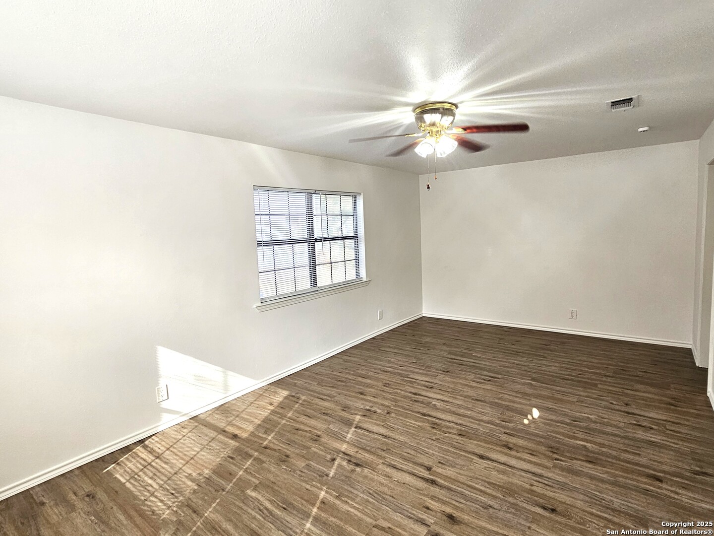 105 Santa Clara Street Cibolo, TX 78108 - Photo 23 of 35 an empty room with wooden floor fan and windows