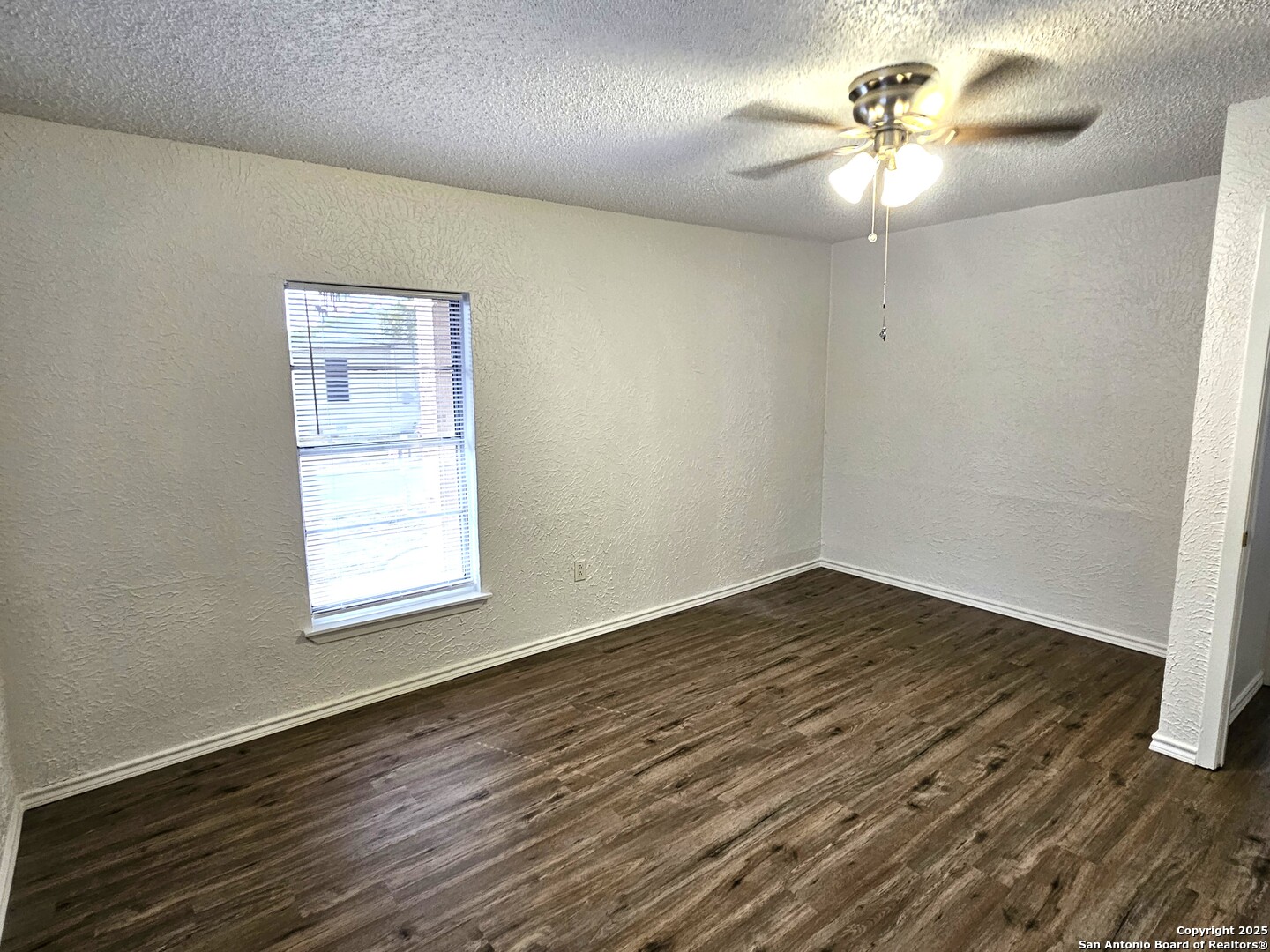105 Santa Clara Street Cibolo, TX 78108 - Photo 24 of 35 an empty room with wooden floor chandelier fan and window