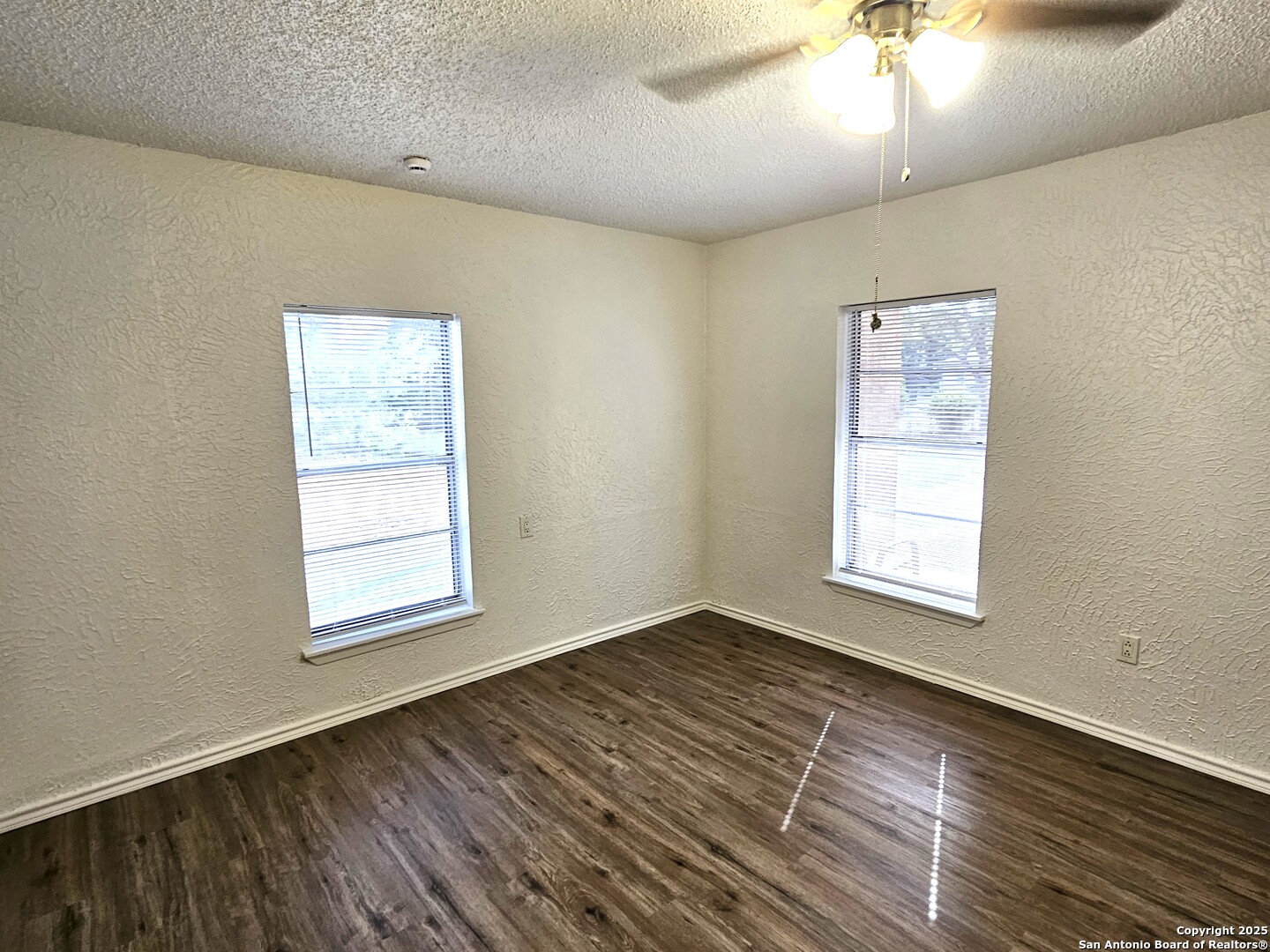 105 Santa Clara Street Cibolo, TX 78108 - Photo 25 of 35 an empty room with wooden floor chandelier fan and windows