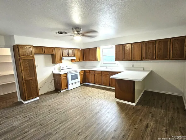 a kitchen with a sink and wooden cabinets