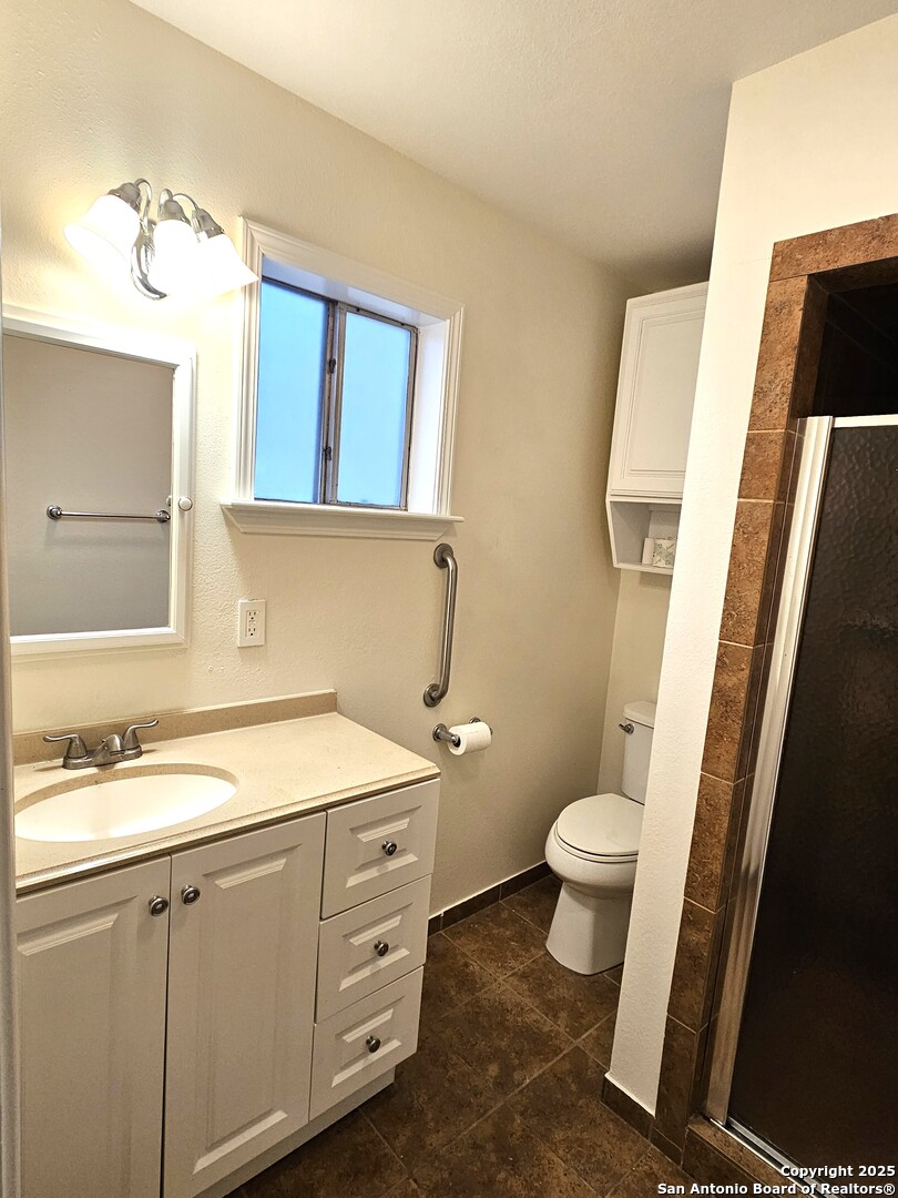 105 Santa Clara Street Cibolo, TX 78108 - Photo 7 of 35 a bathroom with a granite countertop sink toilet and mirror