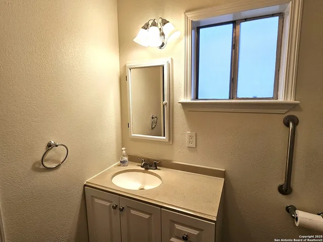 a bathroom with a sink and a mirror