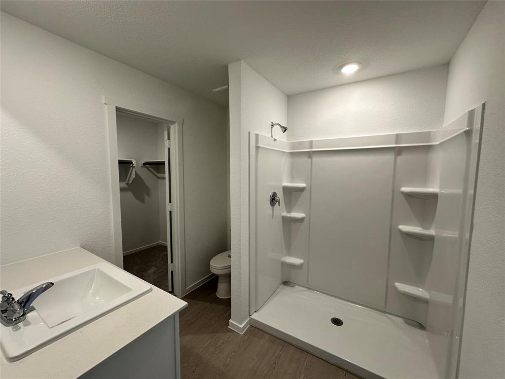 1617 Elliott Road Howe, TX 75459 - Photo 12 of 14 a bathroom with a shower sink and toilet