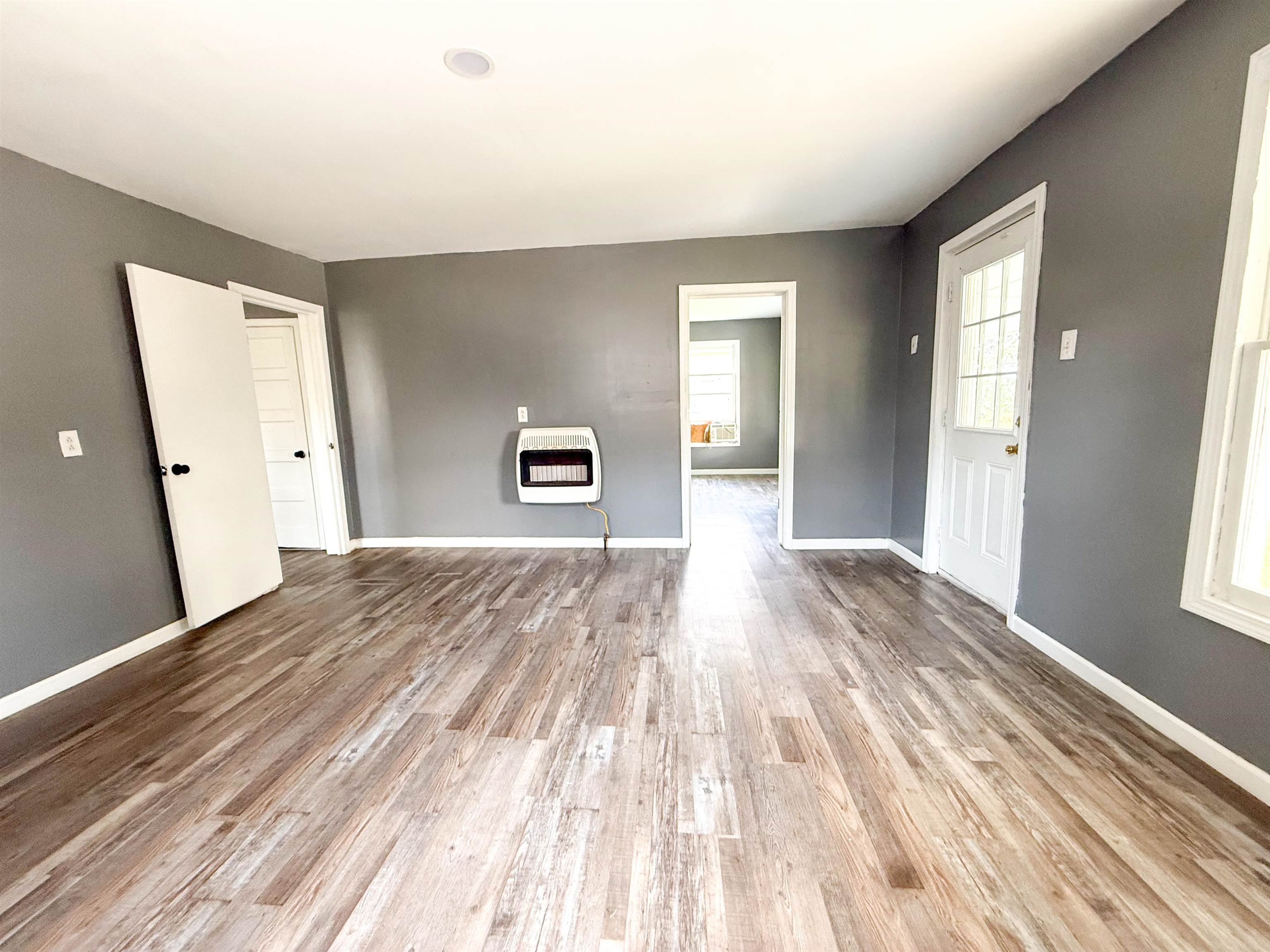 403 Sharp Street Corinth, MS 38834 - Photo 5 of 9 Wood-finish flooring throughout, with neutral wall tones and white trim