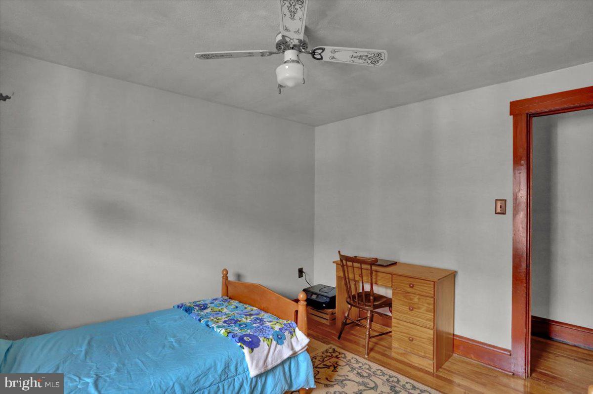 136 West Elm Street Reading, PA 19607 - Photo 16 of 23 a bedroom with a bed and wooden floor