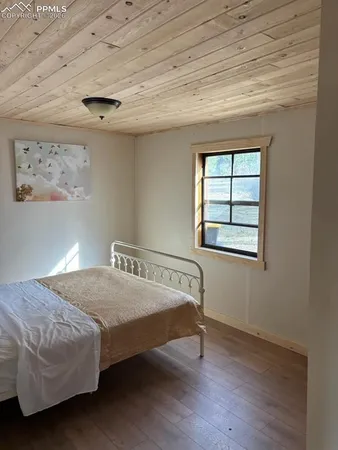 a bed sitting in a bedroom next to a window