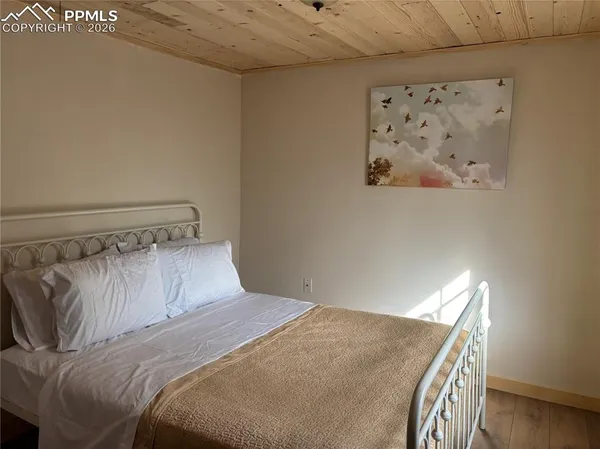 a bed sitting in a bedroom next to a window