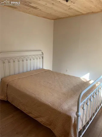 a bedroom with a bed and a desk