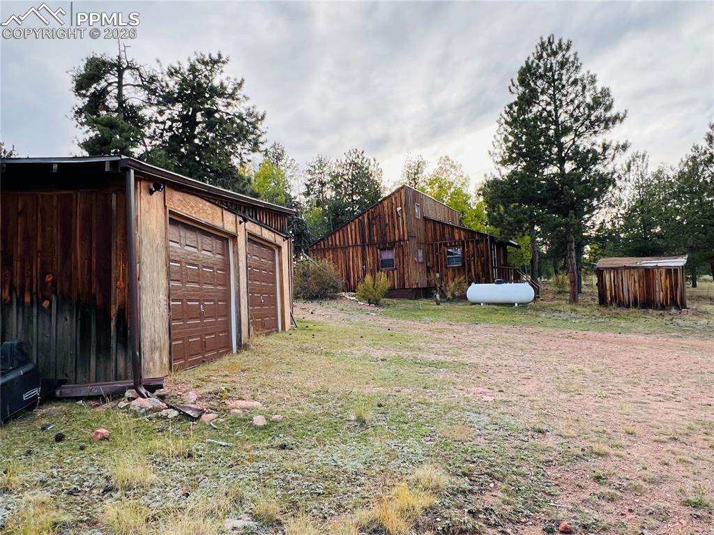 3800 Doe Valley Road Guffey, CO 80820 - Photo 27 of 43 a view of a backyard with potted plants and large tree