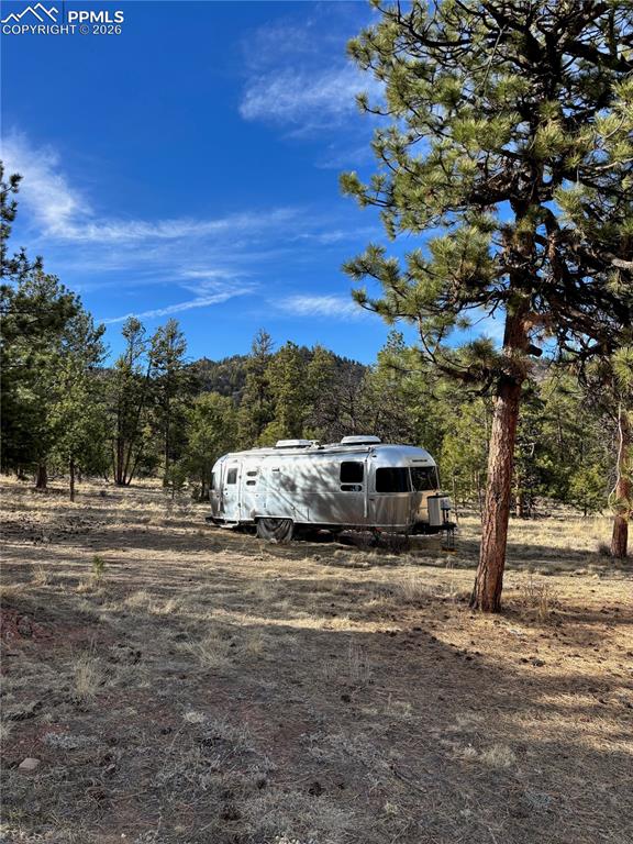 3800 Doe Valley Road Guffey, CO 80820 - Photo 34 of 43 a view of a white house with a yard