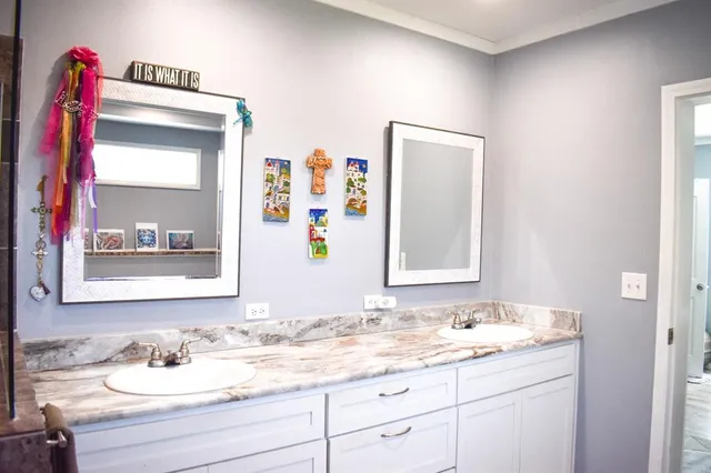 a bathroom with a granite countertop sink and a mirror