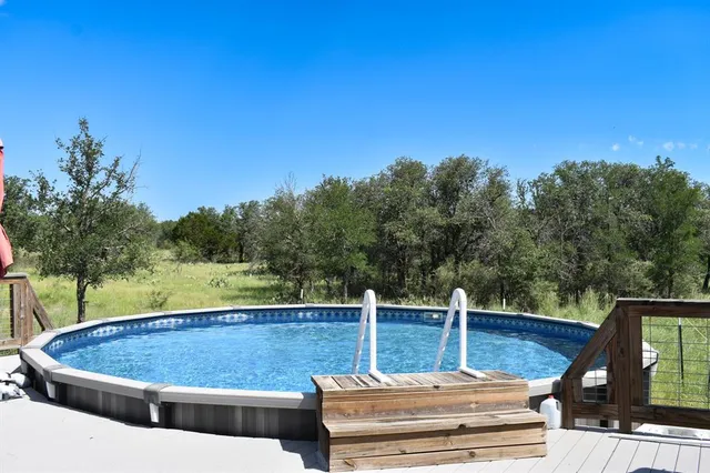 a view of a swimming pool with a patio