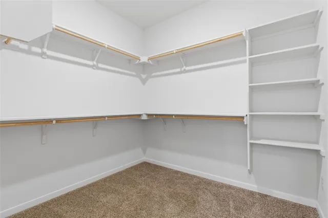 a spacious bathroom with a granite countertop sink and a mirror