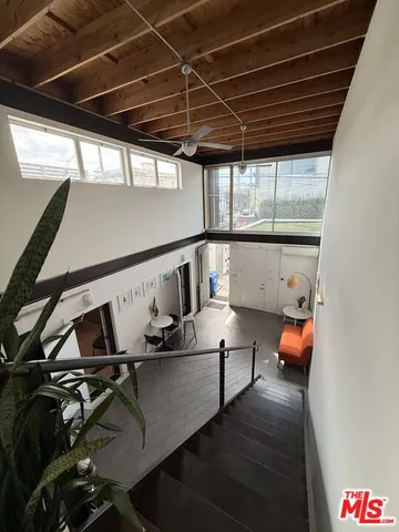 a living room with dining table furniture a lamp and a kitchen view