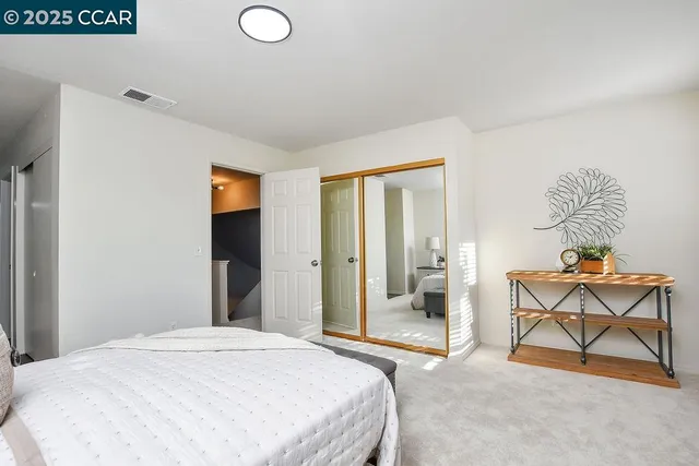 a bedroom with a bed and chair