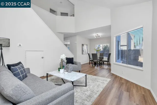 a living room with furniture and next to a window