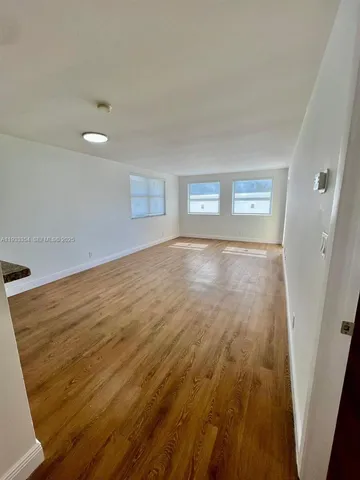 a view of hallway with wooden floor
