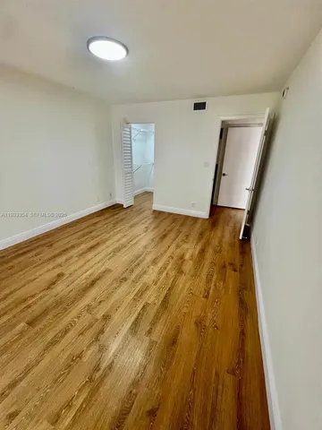 a view of a room with wooden floor