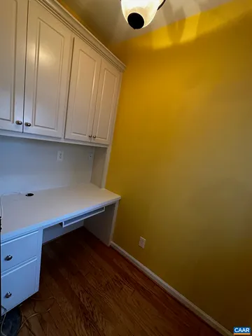 a room with a wooden cabinets and a window