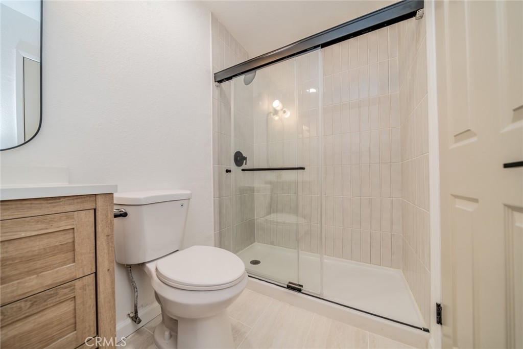 555 North Chestnut Avenue Rialto, CA 92376 - Photo 24 of 33 a bathroom with a shower a toilet and a sink