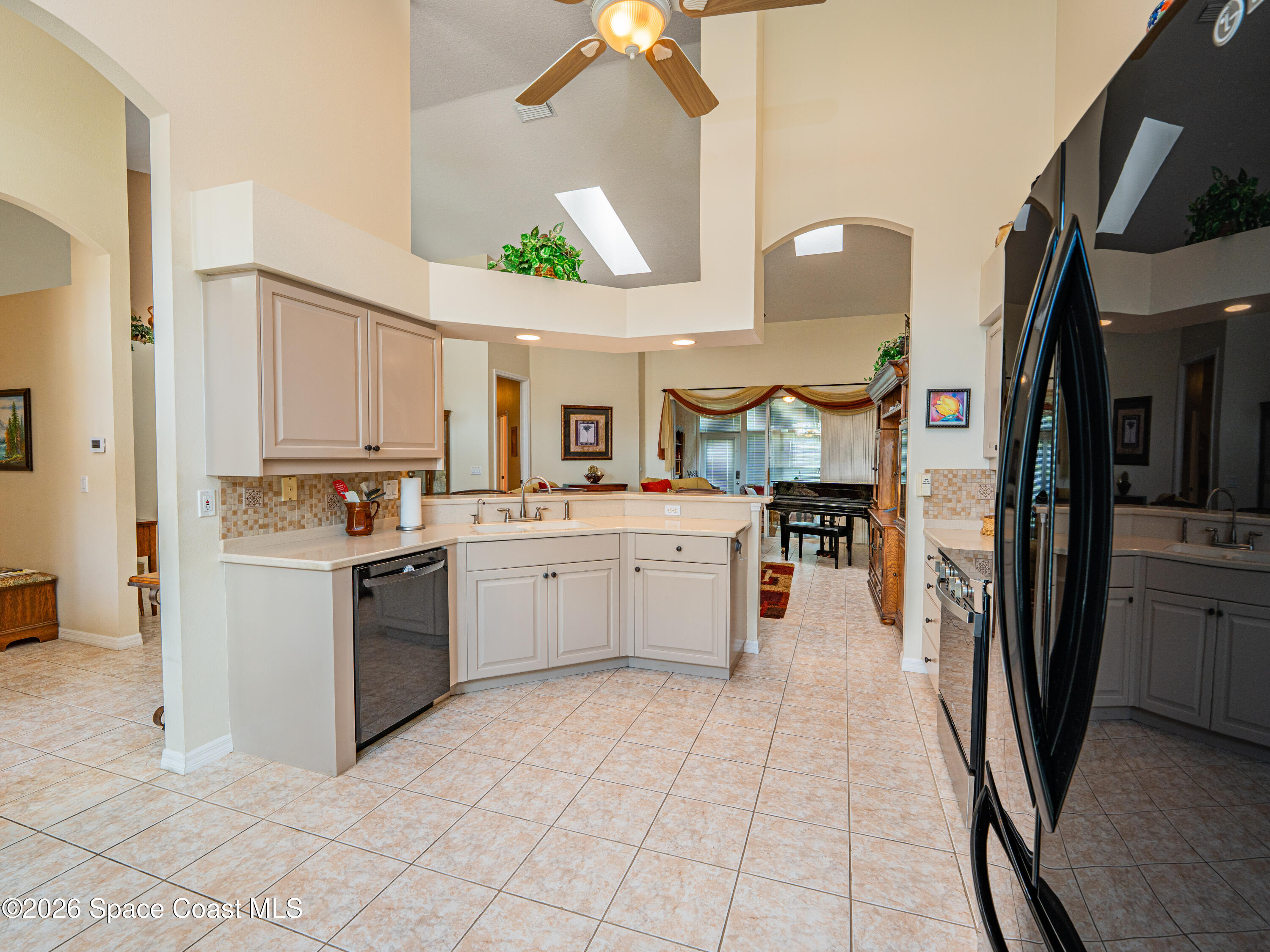 598 Renaissance Avenue Melbourne, FL 32940 - Photo 17 of 56 a large white kitchen with a refrigerator a stove a sink and a cabinets