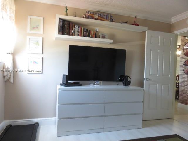 7040 Southwest 24th Street, Unit 104 Miami, FL 33155 - Photo 11 of 27 a living room with a flat screen tv