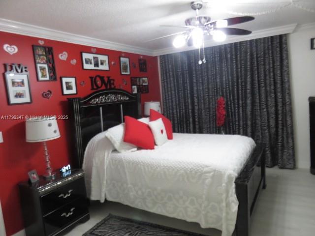 7040 Southwest 24th Street, Unit 104 Miami, FL 33155 - Photo 15 of 27 a bedroom with a bed and a chandelier