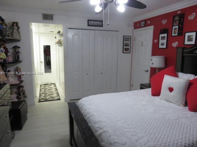 7040 Southwest 24th Street, Unit 104 Miami, FL 33155 - Photo 16 of 27 a bedroom with a bed and a walk in closet