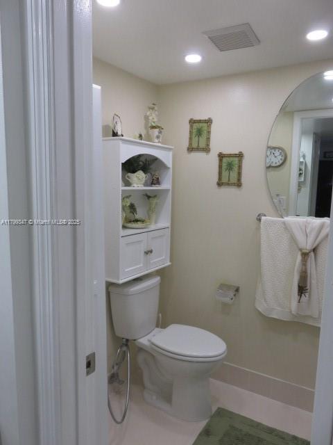 7040 Southwest 24th Street, Unit 104 Miami, FL 33155 - Photo 22 of 27 a white toilet sitting next to a bathroom sink