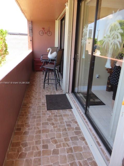 7040 Southwest 24th Street, Unit 104 Miami, FL 33155 - Photo 24 of 27 a view of a balcony with chair and a rug
