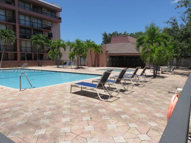 7040 Southwest 24th Street, Unit 104 Miami, FL 33155 - Photo 26 of 27 a view of a swimming pool with a lounge chair