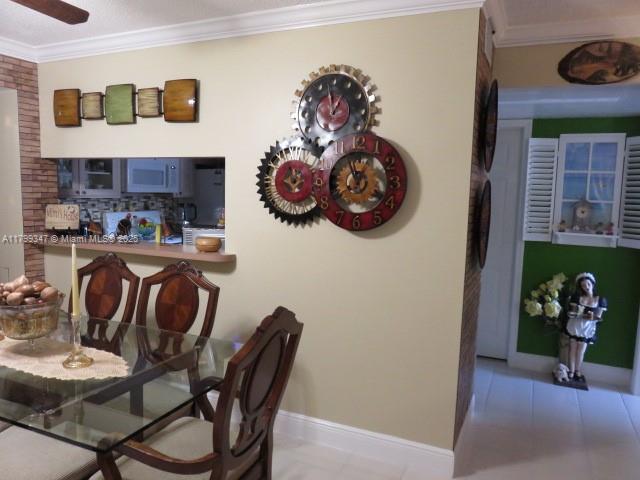 7040 Southwest 24th Street, Unit 104 Miami, FL 33155 - Photo 6 of 27 a view of a dining room with furniture and chandelier