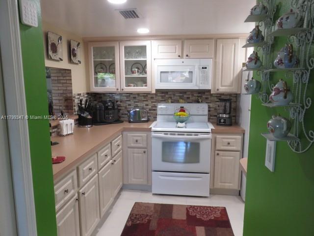 7040 Southwest 24th Street, Unit 104 Miami, FL 33155 - Photo 7 of 27 a kitchen with a sink and cabinets