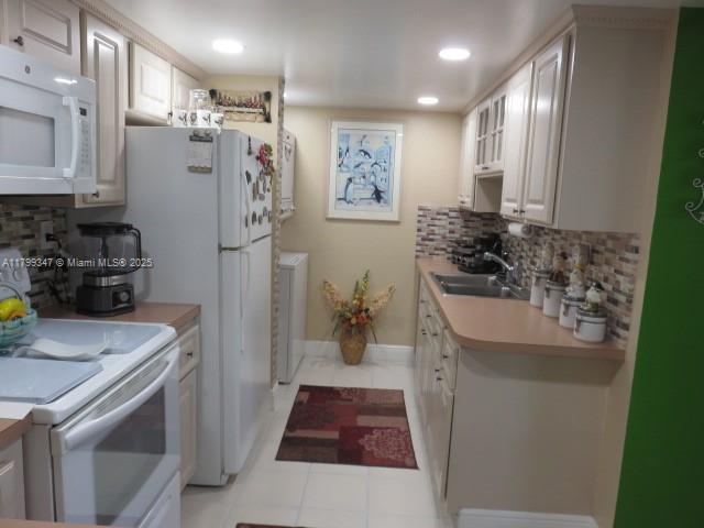 7040 Southwest 24th Street, Unit 104 Miami, FL 33155 - Photo 8 of 27 a kitchen with stainless steel appliances a refrigerator and a stove