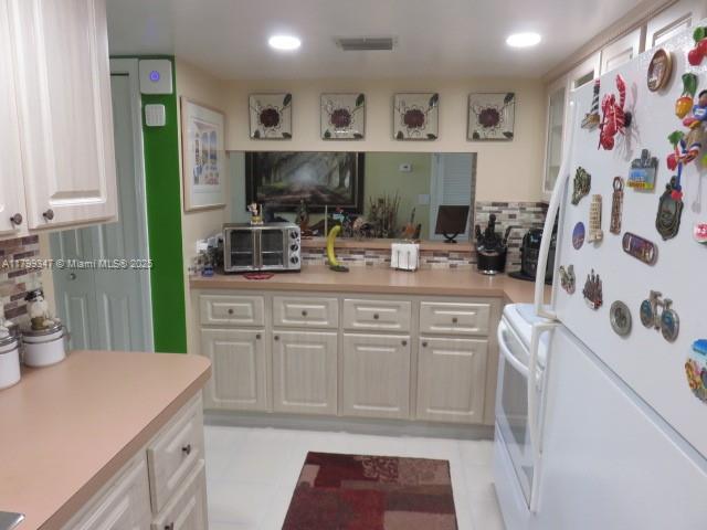 7040 Southwest 24th Street, Unit 104 Miami, FL 33155 - Photo 9 of 27 a kitchen with white cabinets and sink