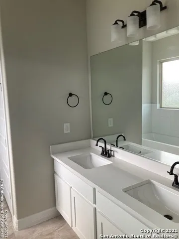 a bathroom with a sink and a mirror