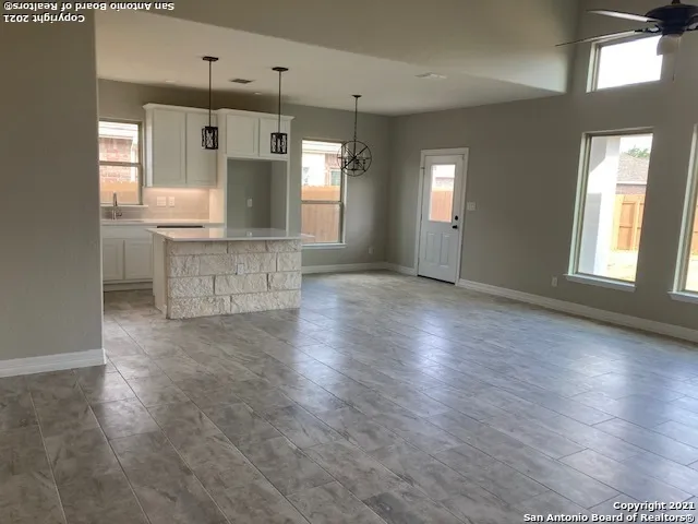 a view of kitchen and hall with wooden floor
