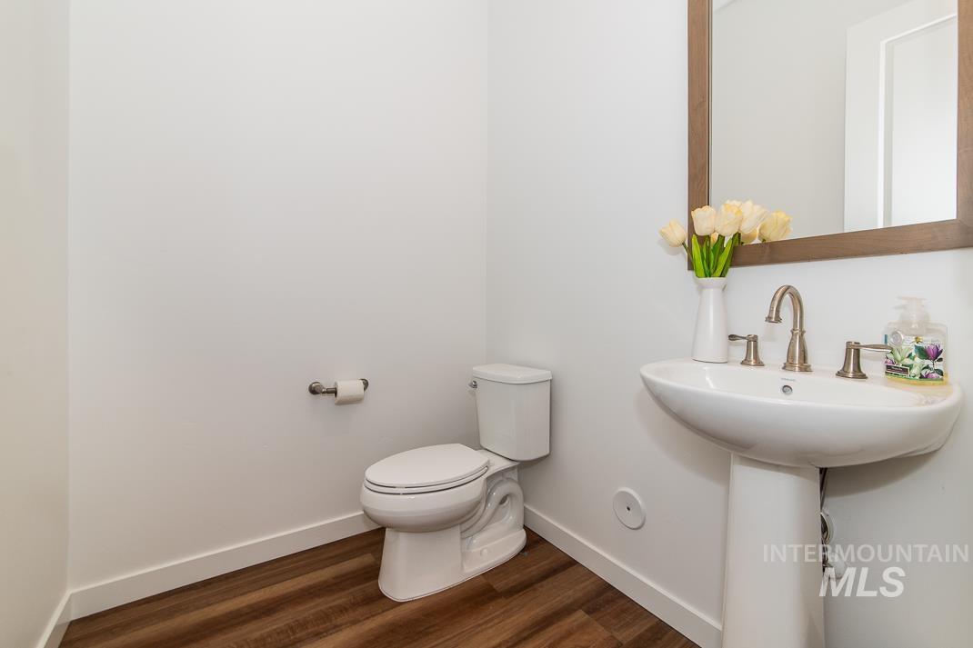 5610 Sparky Avenue Caldwell, ID 83607 - Photo 15 of 27 Half bath with baseboards and dark wood-style flooring