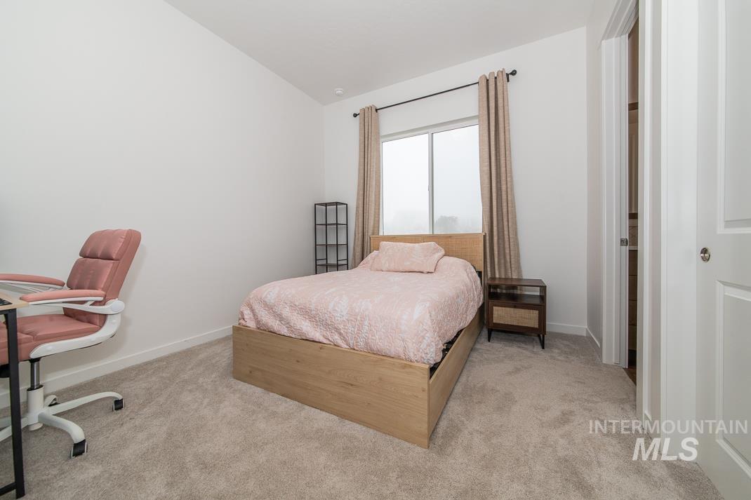 5610 Sparky Avenue Caldwell, ID 83607 - Photo 17 of 27 Bedroom with light colored carpet, an office area, and vaulted ceiling