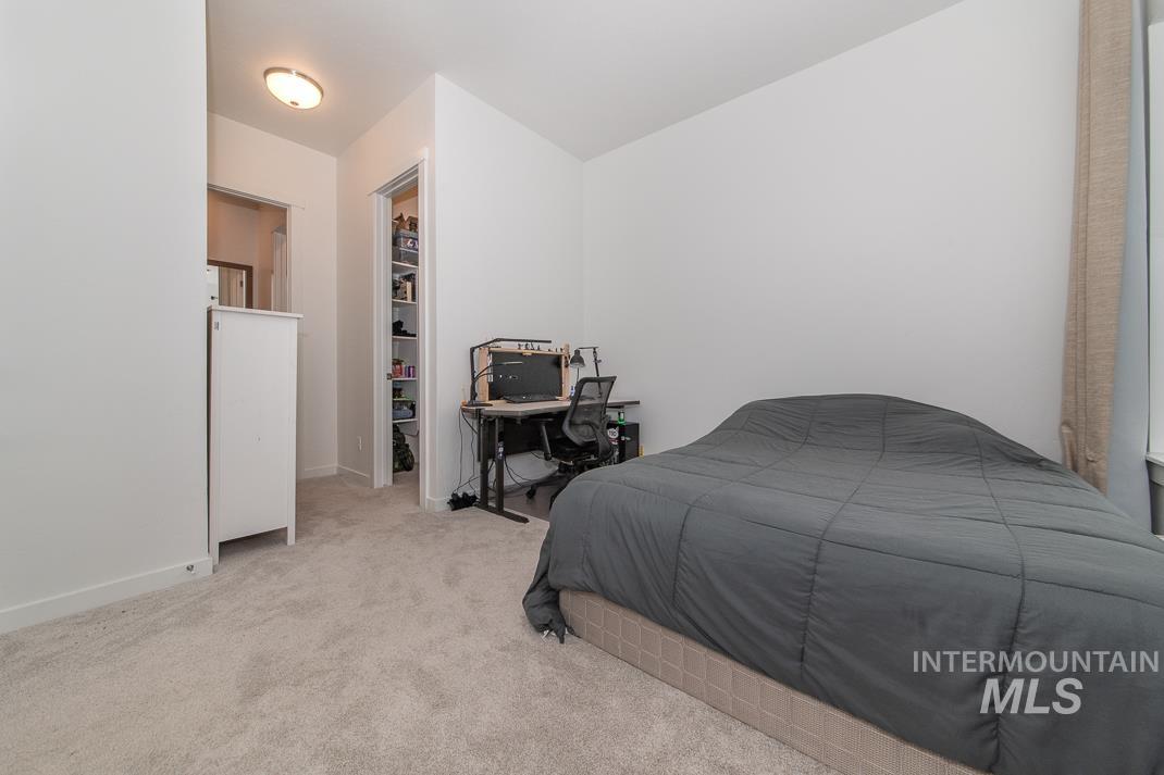 5610 Sparky Avenue Caldwell, ID 83607 - Photo 19 of 27 Bedroom featuring a spacious closet and light carpet
