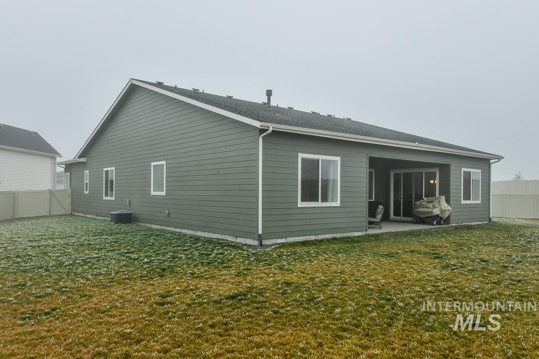 5610 Sparky Avenue Caldwell, ID 83607 - Photo 21 of 27 Rear view of house featuring a fenced backyard and a patio