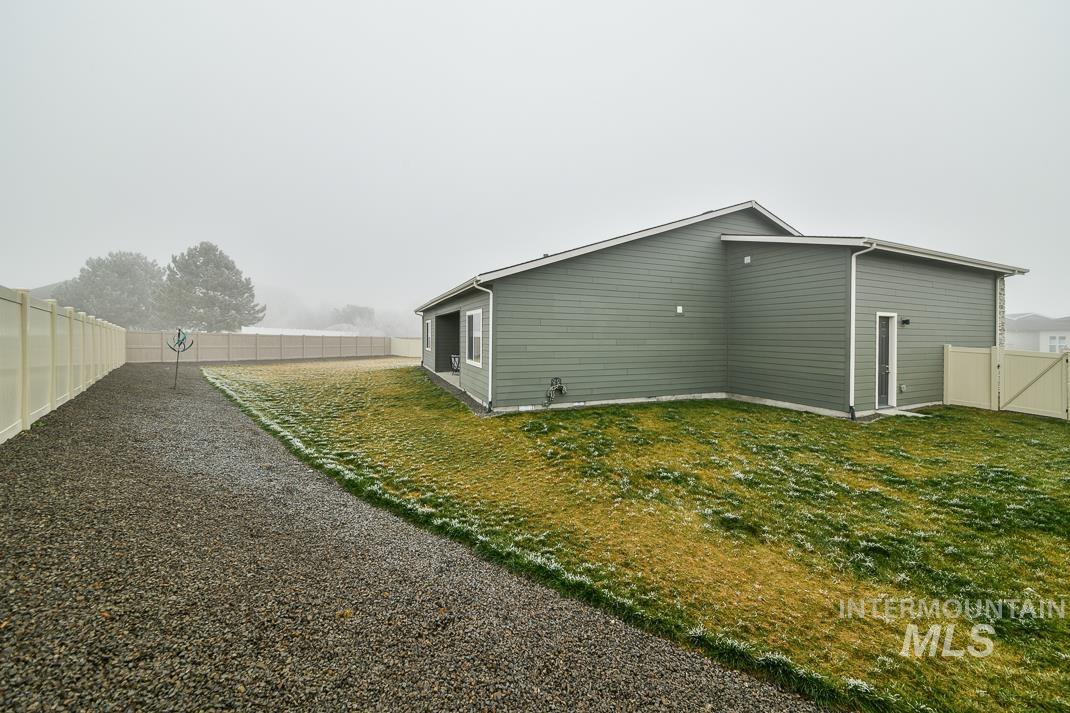 5610 Sparky Avenue Caldwell, ID 83607 - Photo 23 of 27 View of home's exterior with a fenced backyard
