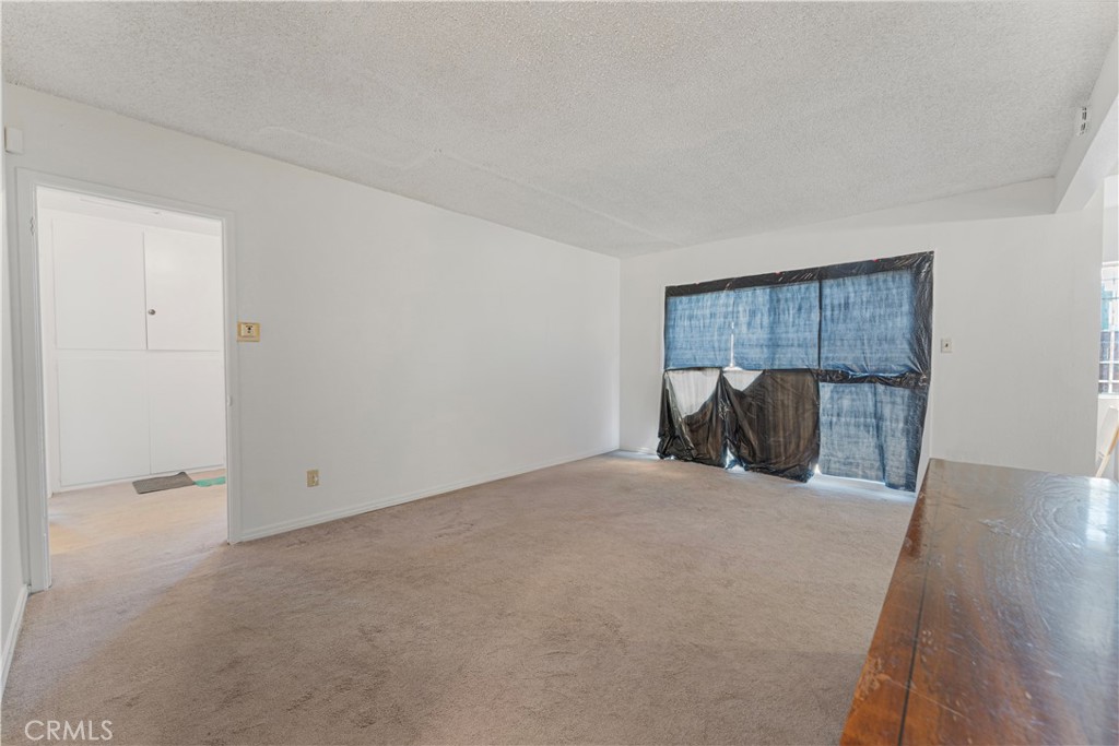 14606 South Caswell Avenue Compton, CA 90220 - Photo 3 of 5 a bedroom with a bed and a mirror